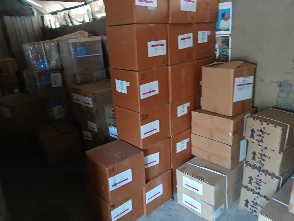 Stacked aid boxes in storage, numbered for tracking.